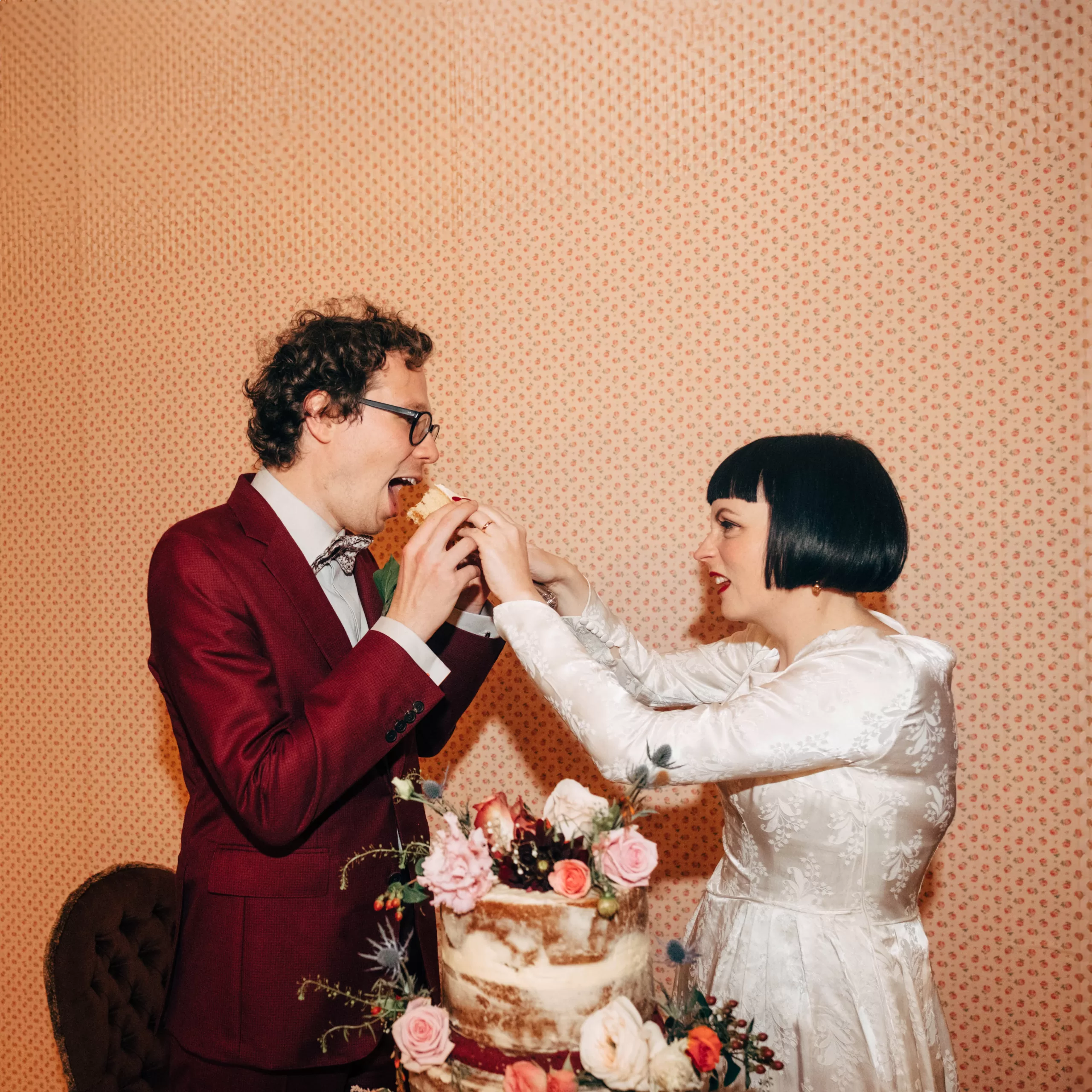 Couple sharing wedding cake captured by alternative wedding photographer Dale Weeks
Sussex