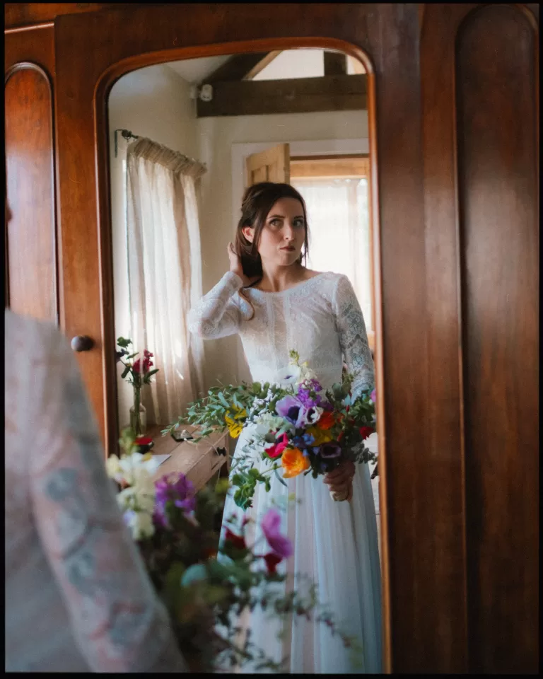 bride looking in the mirror in the chicken suite